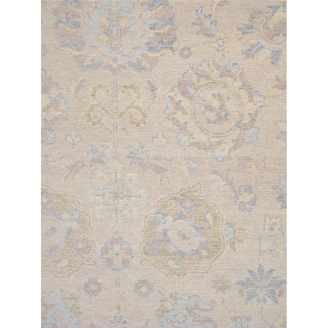 Expertly hand-knotted from fine wool, this Turkish Oushak rug showcases the collection's signature large-scale semi-...