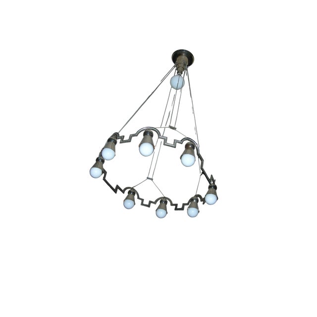 Nickel-plated metal chandelier with 8+1 opal glass lights, geometric ring body, and delicate wire suspension This...