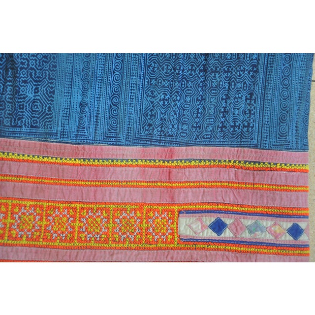 A large Hmong ceremonial or domestic textile cover, constructed from hand-sewn indigo batik, appliqué, and embroidered...