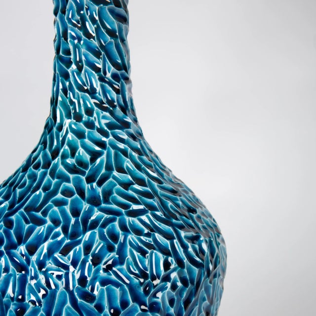 Emphasize sophisticated color and artistry with this contemporary ceramic table lamp design. A crystal base supports a...