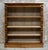 A substantial Victorian open library bookcase dating to circa 1880, constructed from oak and distinguished by its richly...