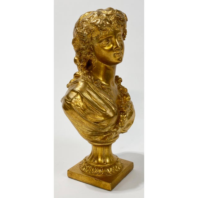 Stunning gilded gold bust of a beautiful maiden draped in flowers. This lovely piece is made of plaster and painted with a...
