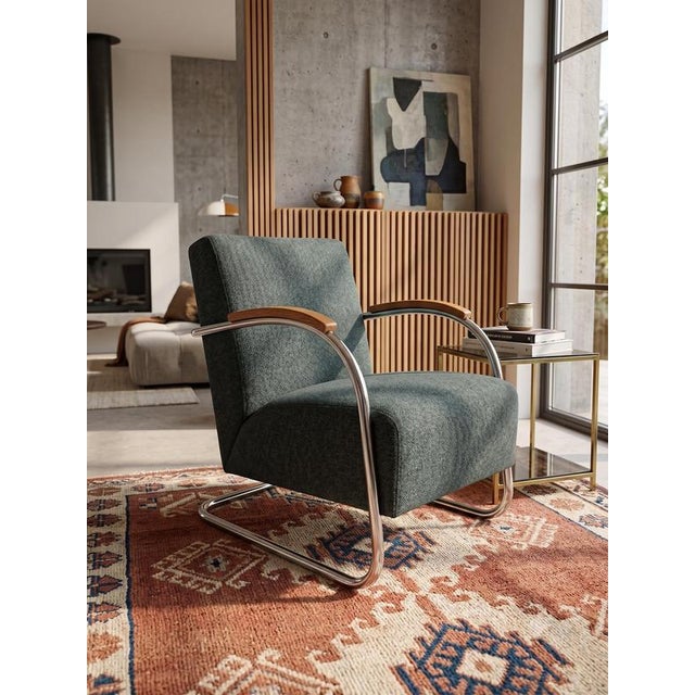An iconic Czechoslovak Bauhaus tubular steel cantilever lounge chair, model Fn 21 "Famos" (locally nicknamed the "D-Chair"...
