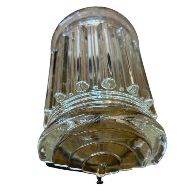This is such a great mid-century glass sconce. Wonderful ribbing and details on thick glass shade with brass backplate. A...