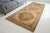 This is a vintage Turkish Oushak rug from the Mid 20th Century. The piece was hand-knotted.