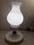 Illuminate your space with this elegant white milk glass table lamp featuring exquisite gold accents. Perfect for adding a...