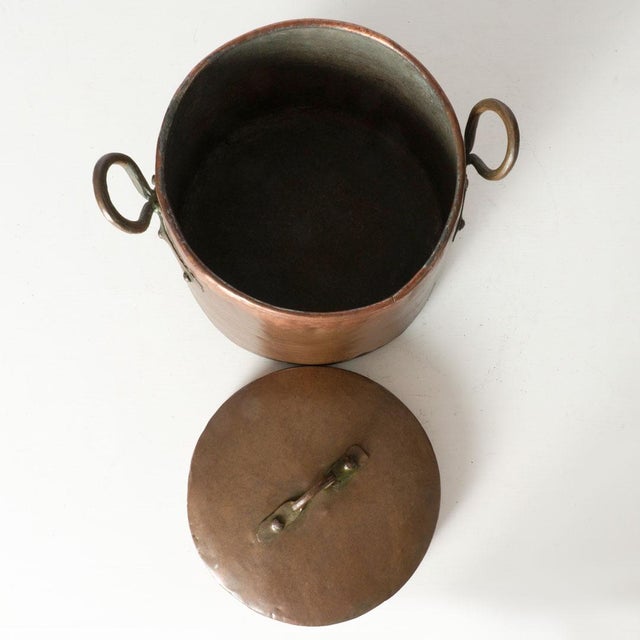 Hand wrought copper double handle pot. Still holds most of its original shine with some light loss on the bottom region...