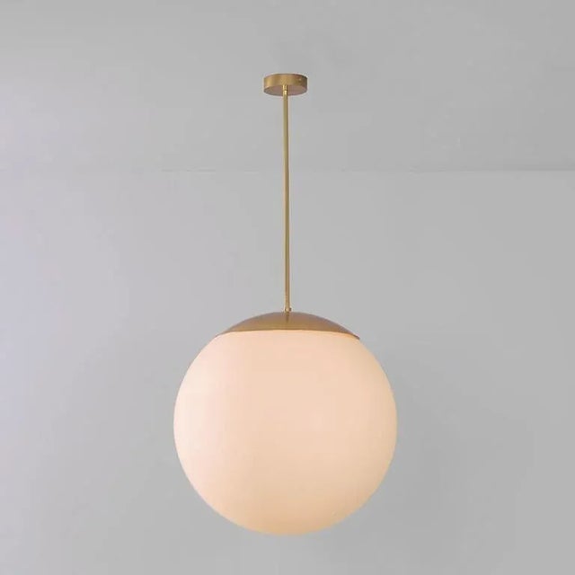 Glass globe opal 60 pendant light by schwung dimensions: w 60 x d 60 x h 125 cm materials: natural brass, hand blown glass...