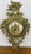 A beautifully decorative Vintage French brass hanging clock featuring an ornate floral and scrollwork design with elegant...