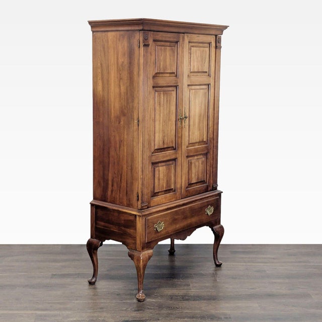 This armoire, in the Queen Anne style is made from solid Cherry wood. It features two paneled doors, three spacious...