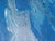 This artwork depicts an astronaut standing in a vast, tranquil sea, holding a whimsical unicorn pool float. The contrast...