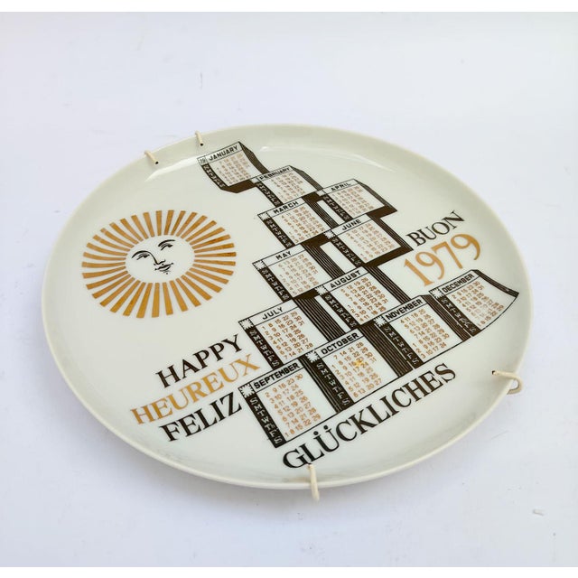 Ceramic Calendar Plate Piero Fornasetti Milano, marked on the back 12th Calendar Plate 1979 White ceramic with gold and...