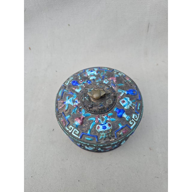 This is an exquisite Chinese enameled brass box with a lid. The lid and sides are decorated in multi-colored enamels. The...