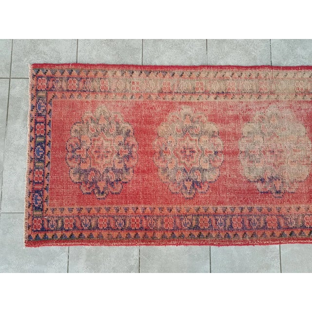 This is a vintage Turkish Oushak rug from the 1960s. The piece was hand-knotted.