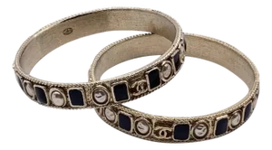 Two 1990s Iconic Gold Plated Metal and Black Enamel Bangle Bracelets by Chanel