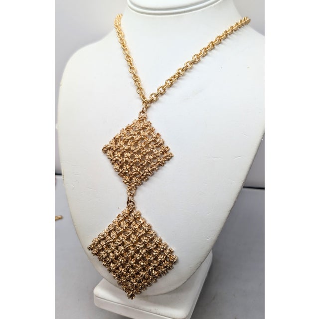 1967 goldtone two diamond shaped woven pendants on the chain necklace with spring ring clasp. Marked "NAPIER ©" on the...