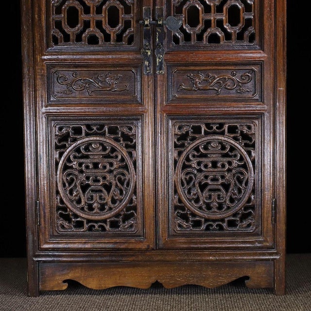 This elegant curio cabinet (bogu gui) is crafted from Chinese rosewood (hua li mu) and designed for displaying and storing...
