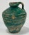 Antique primitive terra cotta jug with handle featuring chippy medium green glaze. Once a common piece of pottery used...
