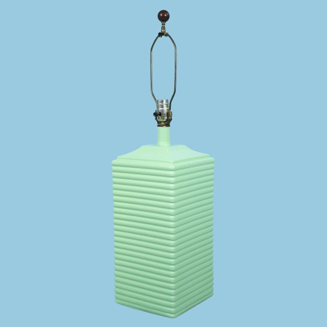 A pair of mid-century green table lamps with a fresh, newly lacquered finish and clean modernist silhouettes. The...