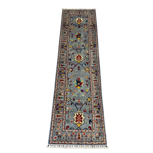 This natural-dyed wool runner features a Persian-style floral design on a blue gray field. Repeating blossoms and...