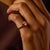 This elegant vintage three stone ring centers on a beautiful 1.04 carat old mine cut diamond, certified by GIA...