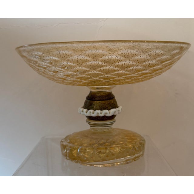 A Mid Century Murano Glass Footed Dish by Barovier and Torso. Hand blown glass with gold flecks throughout. Neck has a...