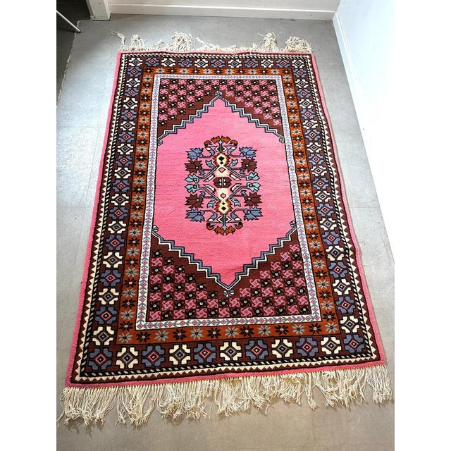 Atmospheric vintage rug featuring a warm colour palette and a distinctive geometric pattern. This hand-knotted rug is made...