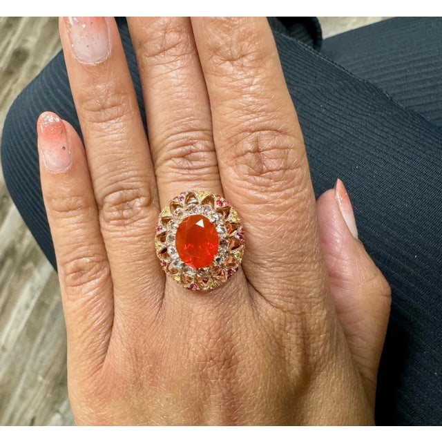 2.93 Carat Fire Opal Rose Cut Diamond Rose Gold Cocktail Ring This ring has a 1.84 Carat Oval Cut Fire Opal as its center...