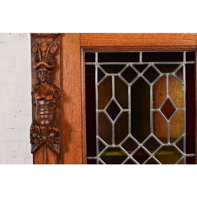 Wood Antique French Renaissance Revival Carved Oak Breakfront Bookcase or Bar Cabinet With Stained Leaded Glass Doors, Circa 1890s For Sale - Image 7 of 14
