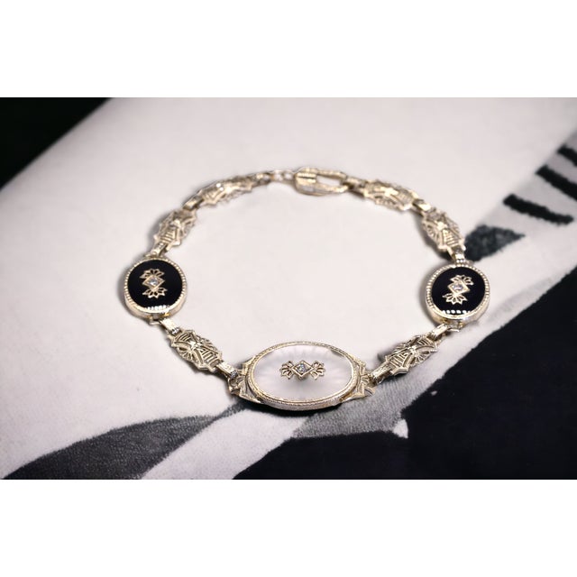 The 48th Street: Antique Art Deco Camphor Glass Bracelet set with Diamonds and Onyx. This bracelet boasts a central oval-...