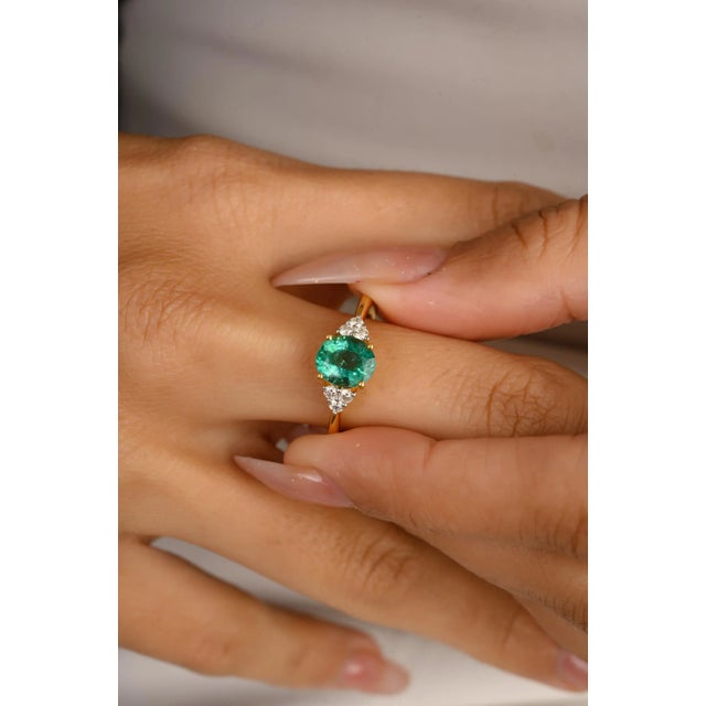 Genuine Oval Shape Emerald and Diamond Wedding Ring in 14K Gold featuring natural emerald of 1.26 carat and diamonds of...