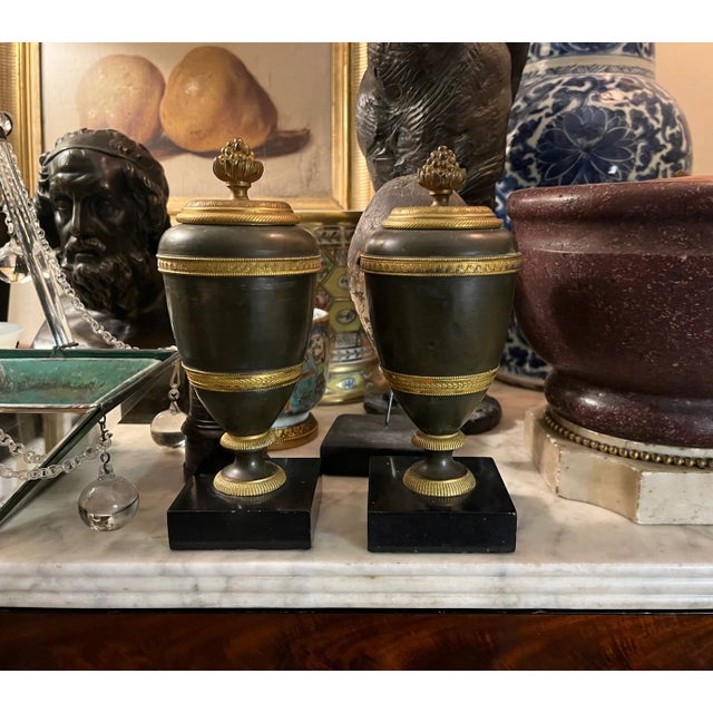 Pair antique early 19th century French Empire gilt & patinated bronze urn form cassoulettes on marble bases circa 1810....
