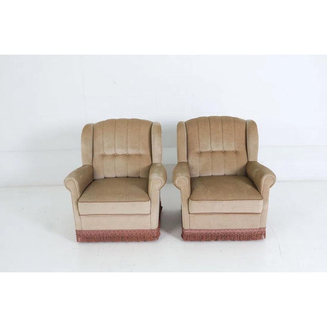 A very nice pair of vintage Danish modern (circa 1960's) bolstered / tufted channel back lounge chairs. The chairs are...
