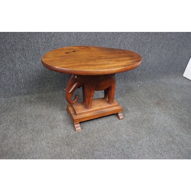 Modern accent table in Cherry with carved elephant base
