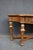 Drexel Heritage console table crafted in cherry and walnut with a gracefully shaped top above a serpentine apron fitted...