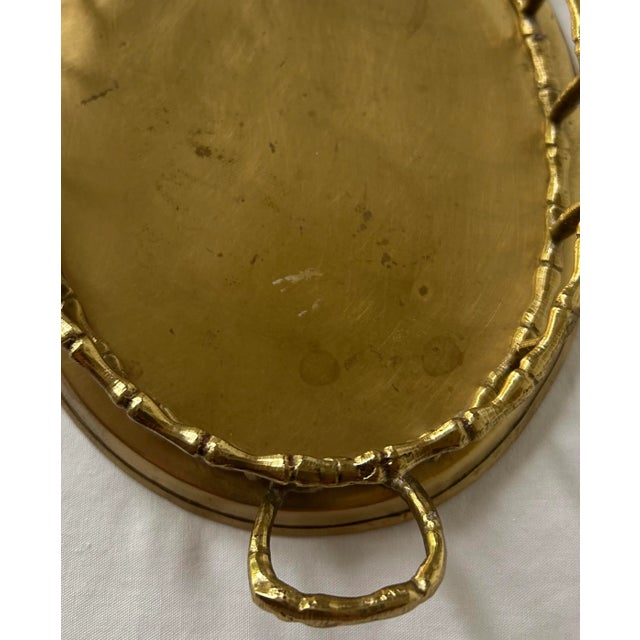 Beautiful bamboo motif gallery edge tray with substantial handles and buttery brass color. Perfect for holding your...