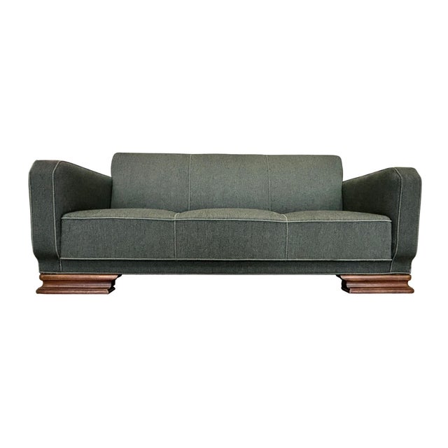 An exquisitely crafted Art Deco sofa from the 1930s. The woven fabric, in a dark green shade, is the original upholstery....