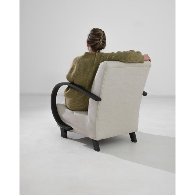 This 1950s Czech Wooden Armchair by J. Halabala is a striking example of early 20th-century modernist design, blending...