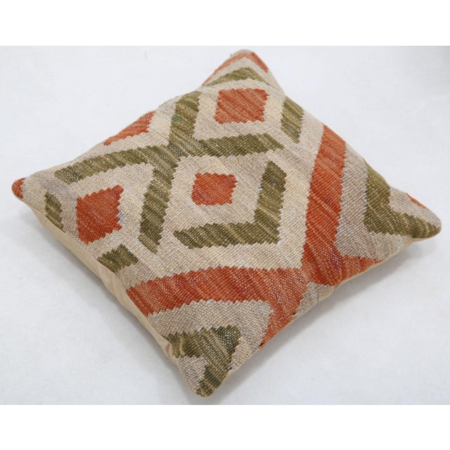 A one-of-a-kind handwoven Afghan wool kilim accent pillow featuring stepped diamond lattice. Cut and sewn by hand from a...