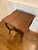 A distinctive antique oak occasional table featuring a beautifully shaped square top with expressive wood grain, a...