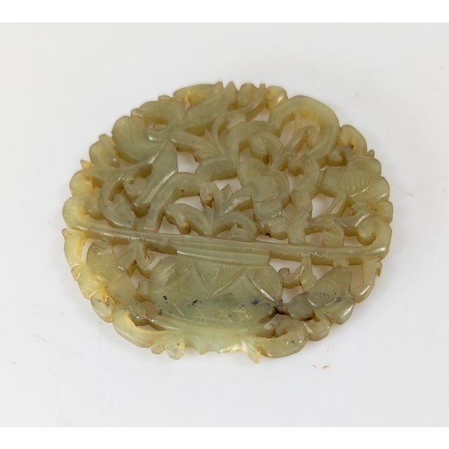 We are selling this nice Chinese carved reticulated Nephrite Jade Pendant. This pendant is dark green celadon color and...