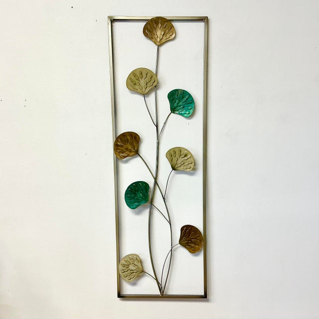 This is a lovely Mid-Century Sculptural Wall Object from the last Mid-Century. It features intertwined vines with fan-...