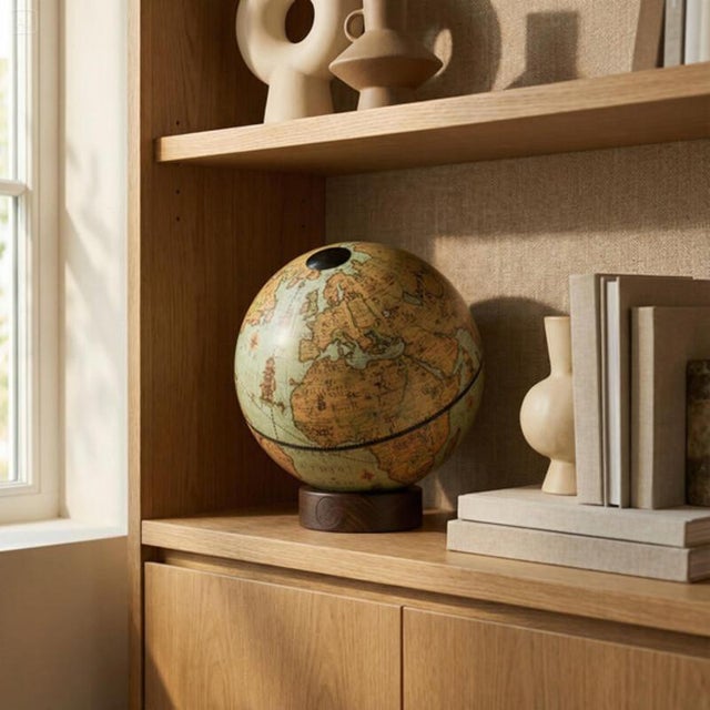 A globe that exudes elegance in its details. The handcrafted Italian beechwood base and aquamarine sphere create a desk...