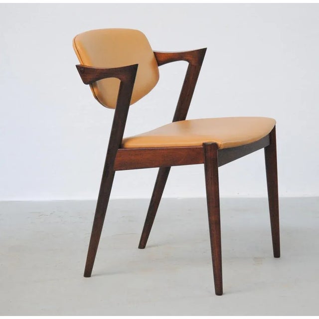 Set of twelve fully restored rosewood dining chairs with adjustable backrest by Kai Kristiansen for Schous Møbelfabrik....