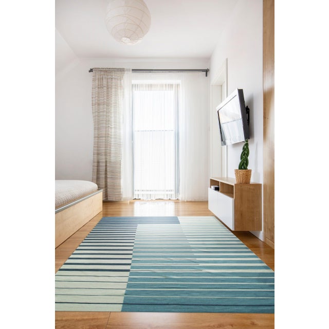 Majestic Laine Multicolor Flatweave Wool Rug, Country of Origin: India. This exceptional piece showcases the minimalist...