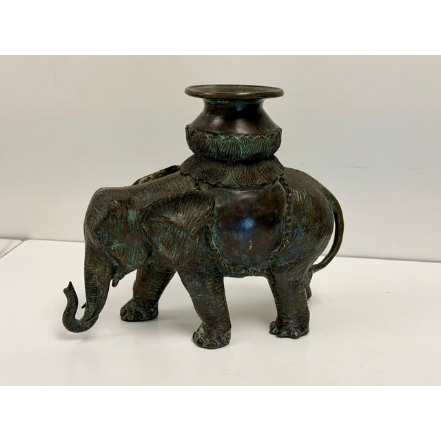 Heavy bronze cast verdigris finished candle holding elephant from Maitland Smith. (Maitland Smith label attached...