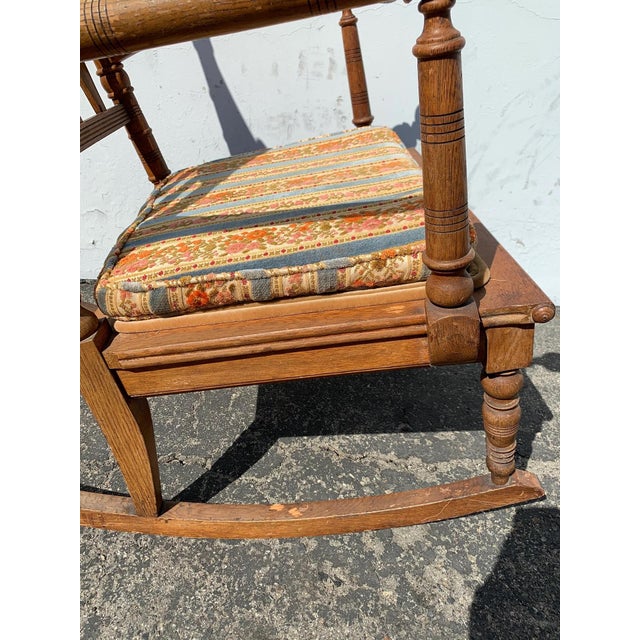 Wonderful antique rocking chair with lots of charm and character. Features a traditional hand turned spindles and adorable...