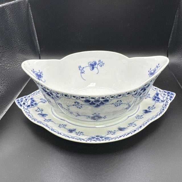 Classic and elegant, this vintage Royal Copenhagen Blue Fluted Half Lace gravy boat with matching underplate is a...