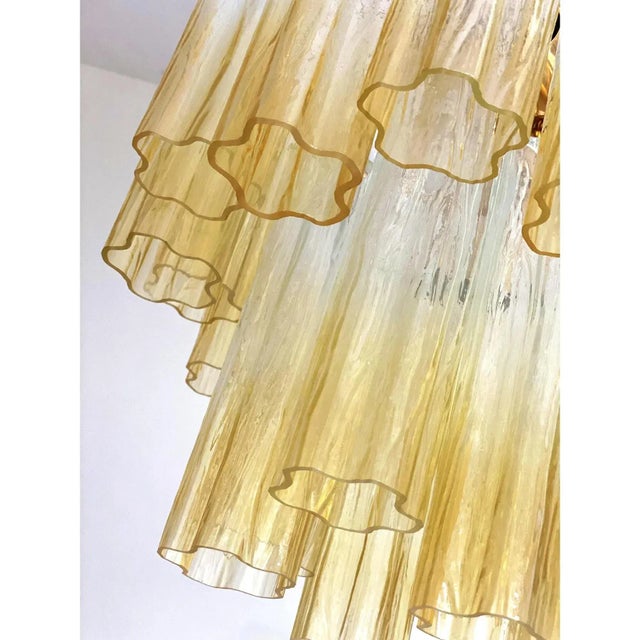 Contemporary murano glass “tronchi” chandelier whit an exclusive brushed-gold 24k metal frame. very rare light amber color...