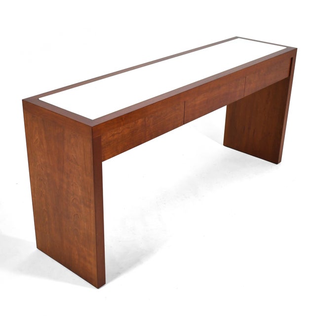 A handsome and practical design, this Conde House console table has three drawers and a white glass inset top. Perfect for...